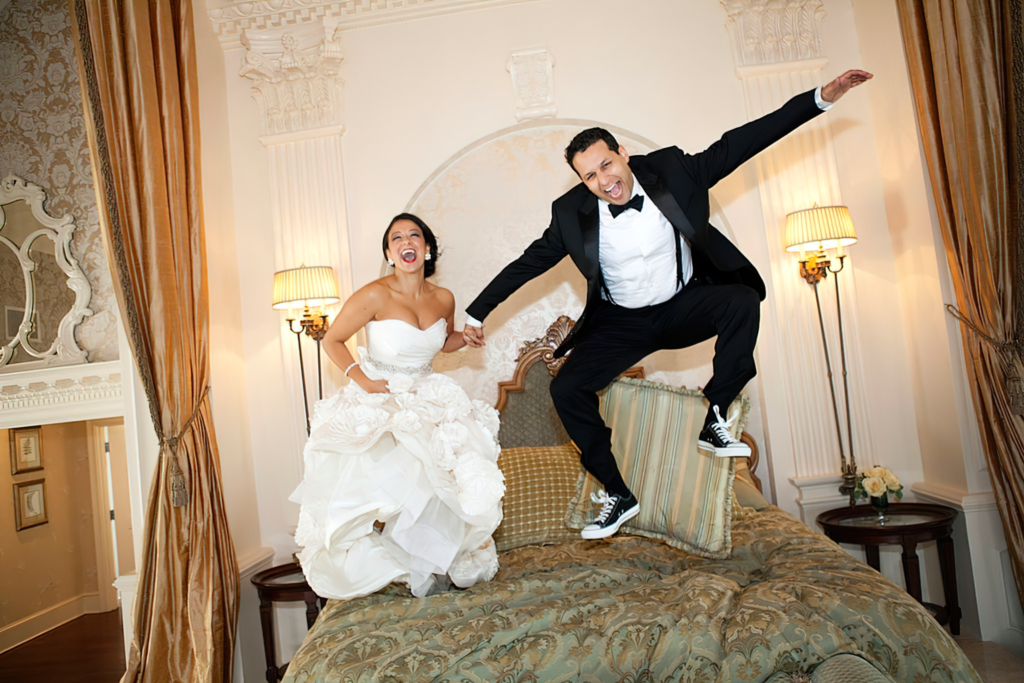 Wedding photographer Norfolk - Wedding Couple Bouncing On The Bridal Sweet Bed