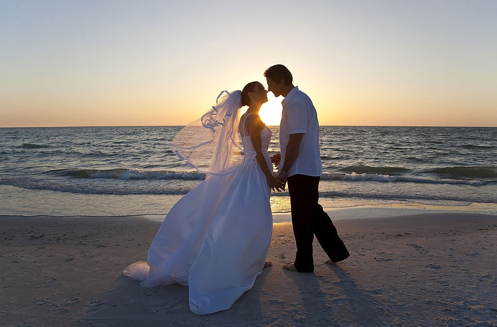 Wedding Photographer bride groom married couple kissing beach